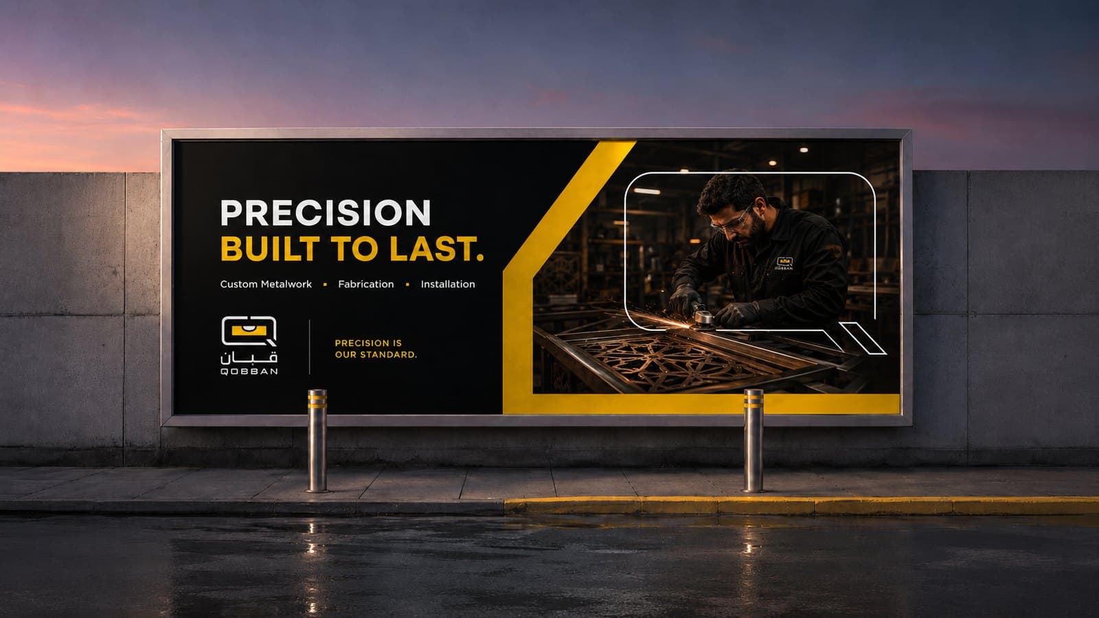 A Qobban roadside billboard at dusk — Precision built to last, over a fabricator cutting a metal screen